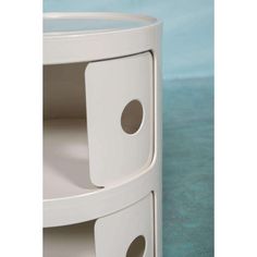 a close up of a white shelf with two holes in the bottom and one hole at the top