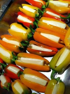 several peppers are lined up on a tray