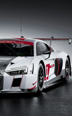 an audi sports car is shown in this black and white photo with red lettering on the side