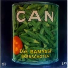 a can filled with green beans and an orange tomato