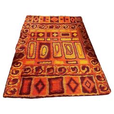 an orange and red area rug on a white background with no one in it or someone else