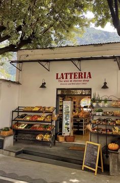 the outside of a store with lots of food on display