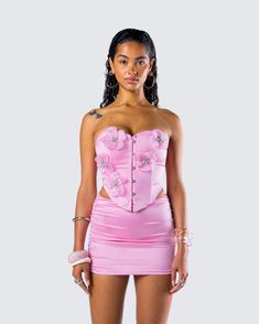 Blossom into your prettiest self in this pink corset top 🌸 Made from soft satin fabric and complete with metal hook & bar closures and a 3D flower appliqué, this look will turn you into everyone's top pick 😉 Light Pink Corset Top, Flower Corset Top, Metallic Outfit, Flower Corset, Black Halter Maxi Dress, Fuzzy Skirt, Pink Corset Top, White Corset Dress, Floral Lace Skirt