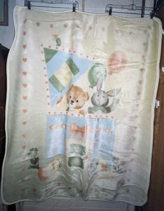 there is a teddy bear and other animals on this blanket hanging from the door way