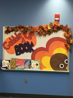 the bulletin board is decorated with fall leaves