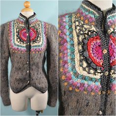 "Vintage 70s/80s artisan hand knit, crochet, embroidered sweater. Large puff/leg o mutton sleeves. Beautiful mother of pearl buttons. The sweater is fitted at the waist, buttons up the front, high neckline. There are many different materials, and elements in this piece, including shiny threads & beads. This is a very unique piece. LABEL: Monte Rosa, Made in Korea SIZE: Refer to measurements for an accurate fit. All sizes are approximate. Shoulder: 15\" Underarm: 32\" Sleeve: 24\" Waist: 29\" Sweater Boho, Embroidered Sweater, Puff Sleeve Top, Mother Of Pearl Buttons, Pearl Buttons, Crochet Sweater, High Neckline, Cardigans For Women, Vintage 70s