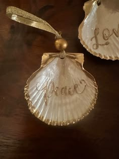 two seashells with the word love written on them are sitting on a table