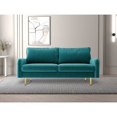 a blue couch sitting on top of a rug in a living room