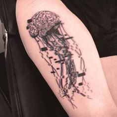 a person with a tattoo on their arm has a jellyfish in it's head