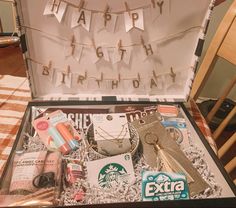 an open suitcase sitting on top of a table filled with assorted items and decorations