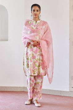 Pink, ivory kurta with floral print, delicate tonal cord finishing on organza. Paired with pant and embroidered dupatta.
Components: 3
Pattern: Printed
Type Of Work: Floral
Neckline: Band collar
Sleeve Type: Three quarter
Fabric: Cotton Silk / Silk Organza
Color: Pink, Ivory
Other Details: 
Sheer panel detailing
Cutwork detailing
Side slits
Occasion: Puja - Aza Fashions New Suit Design, Kurta Set For Women, Embroidered Dupatta, Pink Ivory, Boutique Dress Designs, Silk Suit, Indian Aesthetic, Boutique Dress, Kurta With Pants