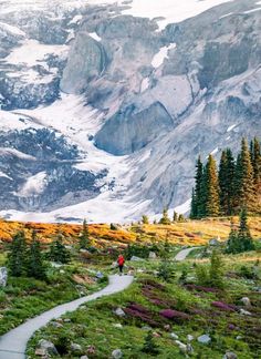 a person walking up a trail in the mountains