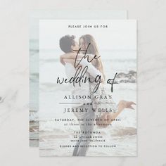 a wedding card with an image of two people kissing on the beach in black and white