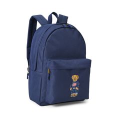 A must-have for school days and weekend adventures this backpack features a roomy design ample pockets and embroidery of our iconic Polo Bear dressed in a signature Ralph Lauren outfit. Back To School Canvas Backpack For Students, Casual School Backpack With Logo Patch, School Backpack With Pockets Made Of Cotton, Casual College Standard Backpack, Cotton School Backpack, Back To School Spirit Backpack, Casual School Backpack, Preppy Backpack For Students Back To School, Preppy Backpack For Back To School