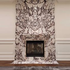 a marble fireplace in a room with white walls