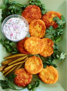 some food is laying out on a plate with dip and parmesan cheeses