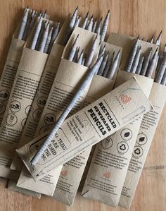 several pencils are lined up on top of each other, with the end wrapped in brown paper