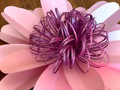 a close up of a pink flower on a table