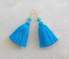 "These are a hand-crafted pair of earrings that have been made from colored cotton yarn and round turquoise beads. They will be a perfect gift for the bohemian style lovers or for yourself to enjoy! Length 3.2\" About Shipping: **Free Worldwide Shipping on Orders Over $35** Delivery time for regular airmail is 14-20 days. Please track your order below: https://www.dhl.com/global-en/home/tracking.html Or USPS.com (for US address) We recommend DHL Express shipping upgrade and your order will arriv Yellow Tassel Earrings, Green Tassel Earrings, Blue Tassel Earrings, Blue Tassel, The Bohemian, Boho Stil, Estilo Boho, Turquoise Beads, Tassel Earrings