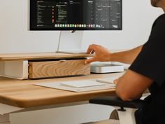 a man sitting at a desk with a computer on it