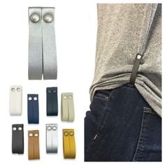 several different colors and sizes of leather straps on a person's back with their hands in the pockets