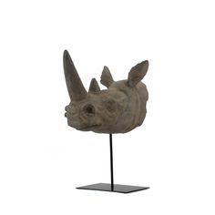 a sculpture of a rhino head on a stand