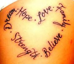 the back of a woman's shoulder with writing on it and an image of a heart