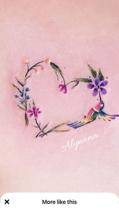 the back of a woman's stomach with flowers and hummings on it, which is