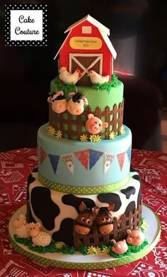 a three tiered cake decorated with farm animals