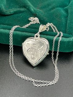 Vintage  silver locket for women. Double sided silver locket with hand engraved back and front. Double photo locket.   Silver heart locket. Silver pendant . Silver necklace for women.       Vintage circa 70s. Condition: necklace in perfect vintage condition. Materials: Silver. Rhodium plated silver chain.  Measure: chain 16"/ 41 cm,   Locket  0.7" x 0.7"/  1.8 x 1.8 cm. Package: gift wrap available, please specify when ordering. Delivery: your order will be send by Royal Mail with tracking and s Anniversary Jewelry Locket In Medallion Shape, Silver Locket For Valentine's Day, Silver Round Locket Necklace For Valentine's Day, Silver Locket Necklace For Valentine's Day, Silver Engraved Necklace For Anniversary, White Gold Pendant Locket Necklace Gift, Silver Jewelry For Mother's Day Keepsake, Victorian Locket Necklace With Hallmark As Gift, Victorian Hallmark Locket Necklace Gift