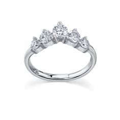 a white gold ring with three pear shaped diamonds on the side and four smaller pears at the top