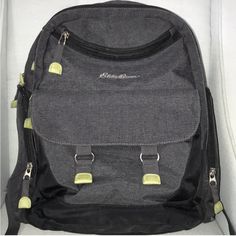 a black and grey backpack with yellow tags