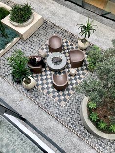 an overhead view of a patio with chairs and plants