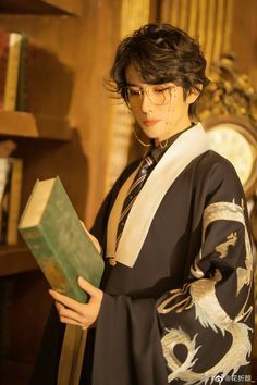 a woman in a kimono is holding a book and looking at the camera while standing next to a bookshelf