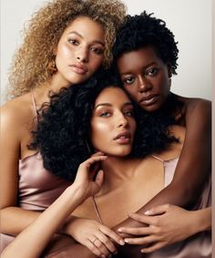 three women are posing for the camera with their arms around each other