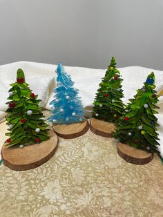 three small christmas trees sitting on top of a table