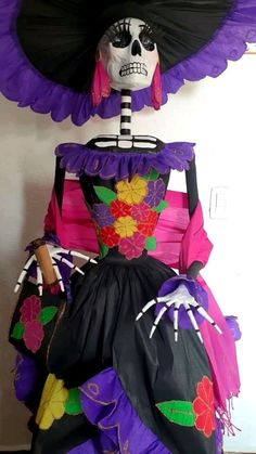 a skeleton in a dress made out of paper