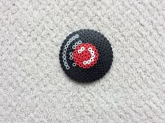 a black and red object sitting on top of a white carpet