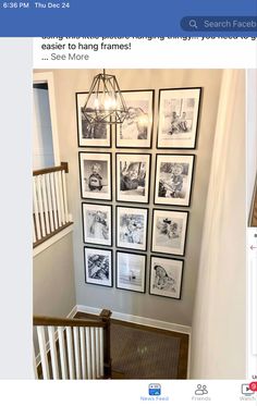 a bunch of pictures hanging on the wall in a room with stairs and railings