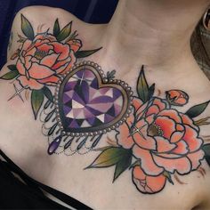 a woman's chest with flowers and a heart on it