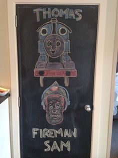 a chalk drawing of thomas the train and fireman sam on a blackboard door