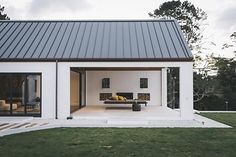 a white house with an open patio and sliding glass doors