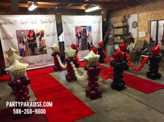 balloons are arranged in the shape of stars and numbers on red carpeted flooring