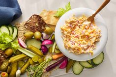 a plate of food with bread, crackers and vegetables