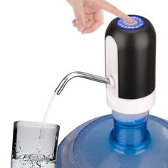 a person is filling a glass with water from a blue and white bottle into a container