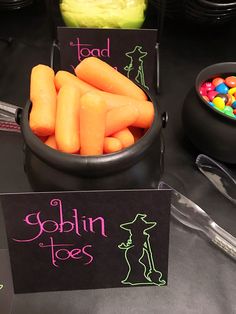 there are carrots and candy in bowls on the table with name tags that say gobin toes