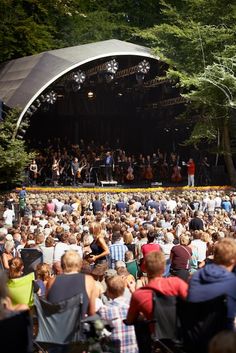 a large group of people sitting in front of a stage