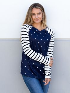 Looking for a stylish and comfortable top to wear this fall and winter? Look no further than our Polka Dot Stripe Raglan Top in classic black! Made from super soft and cozy fabric, this top is perfect for running errands or dressing up with a cute skirt for a night out. The raglan style adds a touch of sporty chic to any outfit, while the polka dot and stripe pattern gives it a fun and playful twist. Size: Small 0-4 Medium 6-8 Large 10-12 XL 12-14 Knit Tops With Striped Long Sleeves, Casual Knit Tops With Striped Sleeves, Fall Relaxed Fit Top With Striped Sleeves, Relaxed Fit Tops With Striped Sleeves For Fall, Casual Winter Tops With Striped Sleeves, Knit Tops With Striped Sleeves For Fall, Knit Crew Neck Tops With Striped Sleeves, Knit Tops With Striped Sleeves And Crew Neck, Fall Knit Top With Striped Sleeves