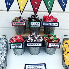 a table topped with buckets filled with candy