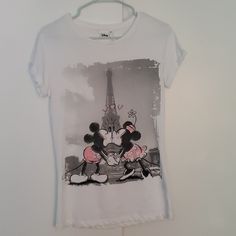 Disney T-Shirt Newest Tag's Paris Theme Size Small Themed Cartoon Print Tops For Disney Trips, Graphic Tee With Character Print For Disney Fan Events, Themed Short Sleeve Tops For Disney Trips, Disney T-shirt With Front Print, Casual Graphic Print Tops For Disney Trips, Themed White T-shirt For Disney Fan Events, White Crew Neck Top For Disney Trips, White Themed T-shirt For Disney Fan Events, Fun Short Sleeve Tops For Disney Trips